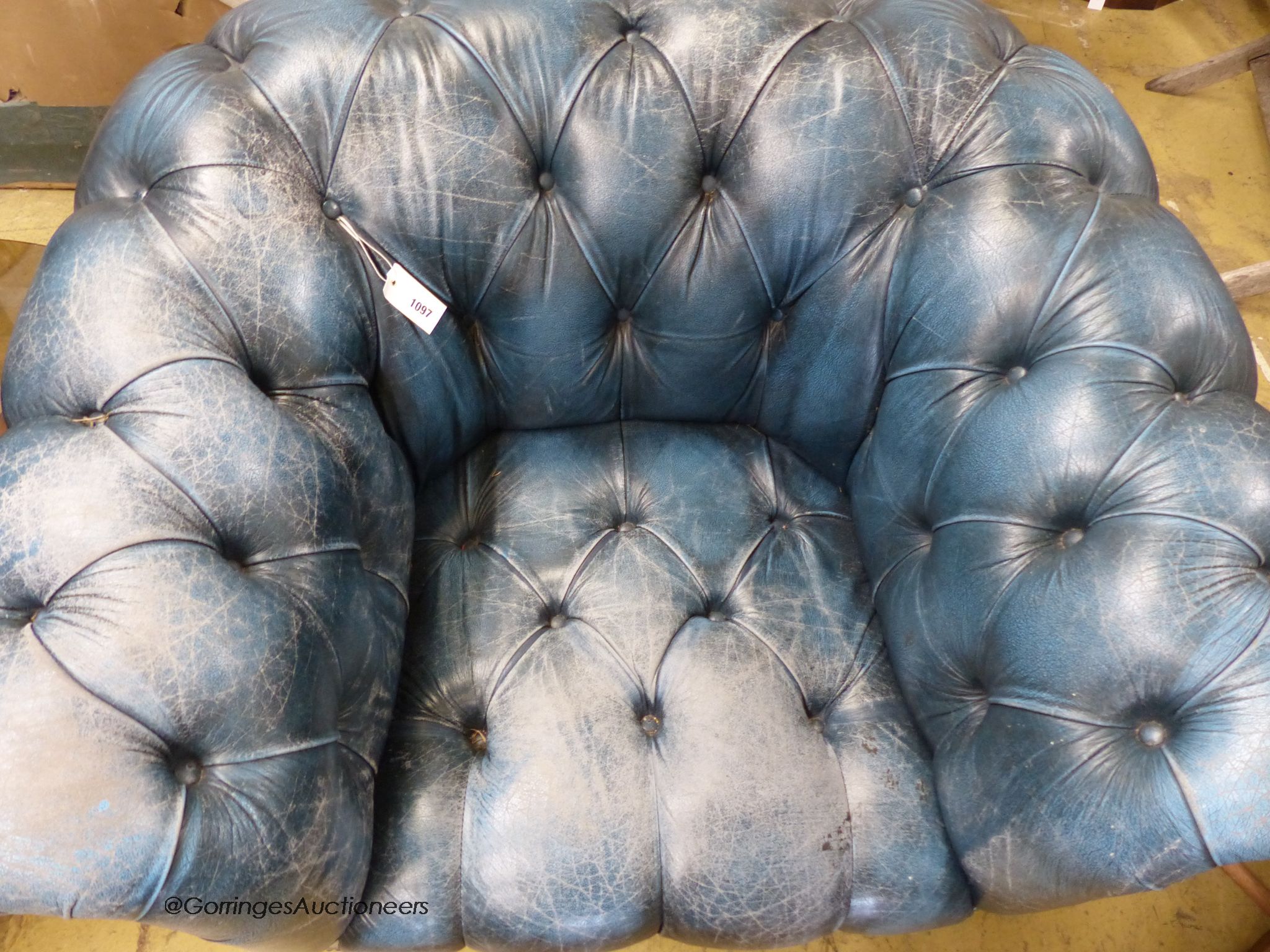 Victorian style, buttoned blue leather chesterfield armchair.